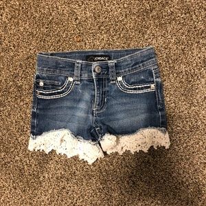 Girl’s Jordache Size 5 jean shorts with white trim.